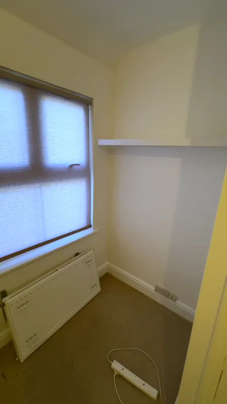 The window wall, with the radiator off for the work — after