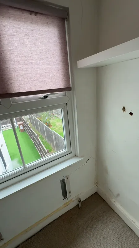 The window wall, with the radiator off for the work — before