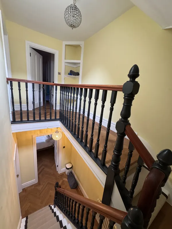 Landing with dark balustrade and newel posts