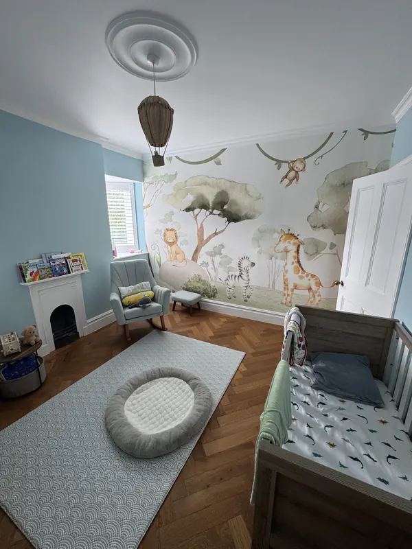 Nursery with mural wallpaper — after