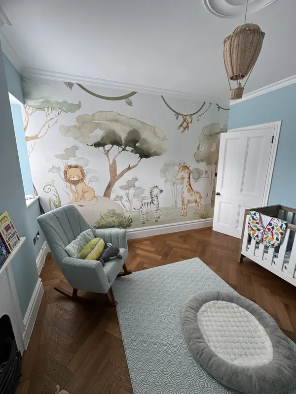 Nursery with mural wallpaper
