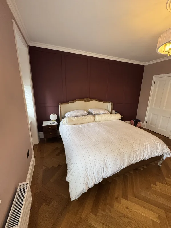 Master bedroom redecorated in Bushey with a panelled feature wall