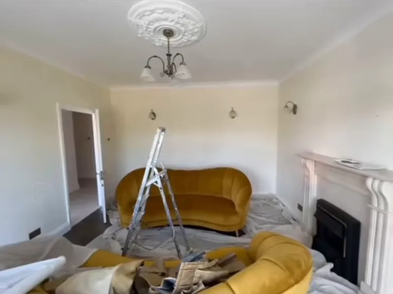 Towards the door and the fireplace — during