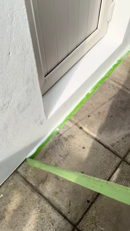 The door and the paving masked off before painting