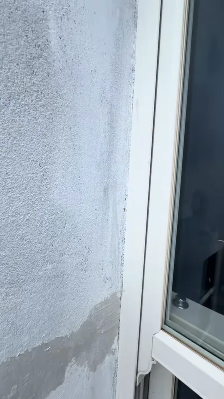 Patchy marks on the wall by a window, before