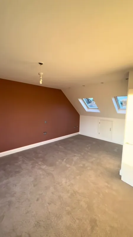 The main bedroom, with its terracotta feature wall — after