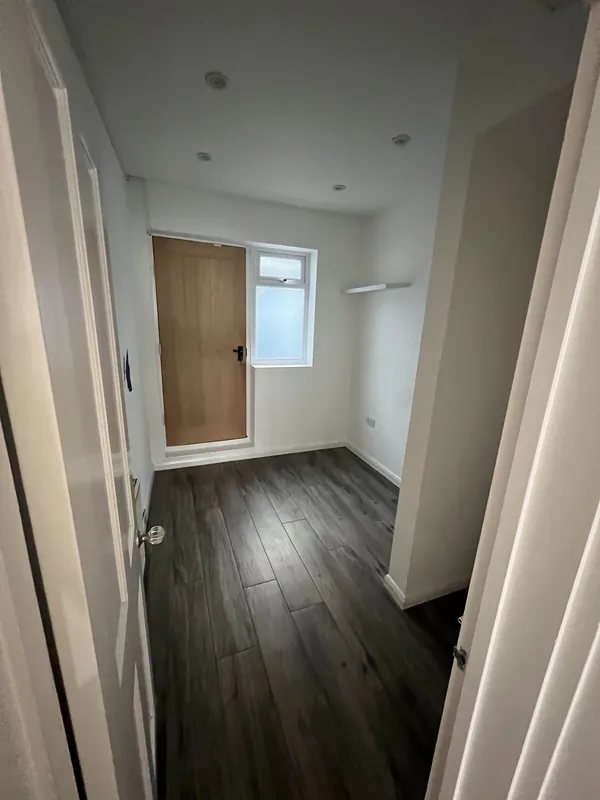 Empty room to a navy waiting area — before