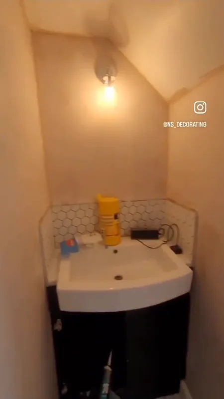 The basin corner under the sloping ceiling — before