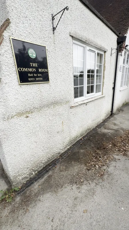 The Common Room side: weathered pebble dash brought back to white — before