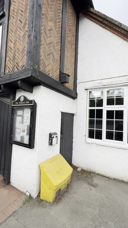 Beside the entrance: pebble dash painted brilliant white — before