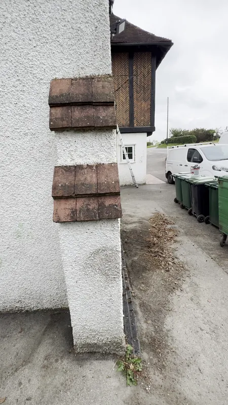 Corner tile creasing cleaned and painted, pebble dash painted — before