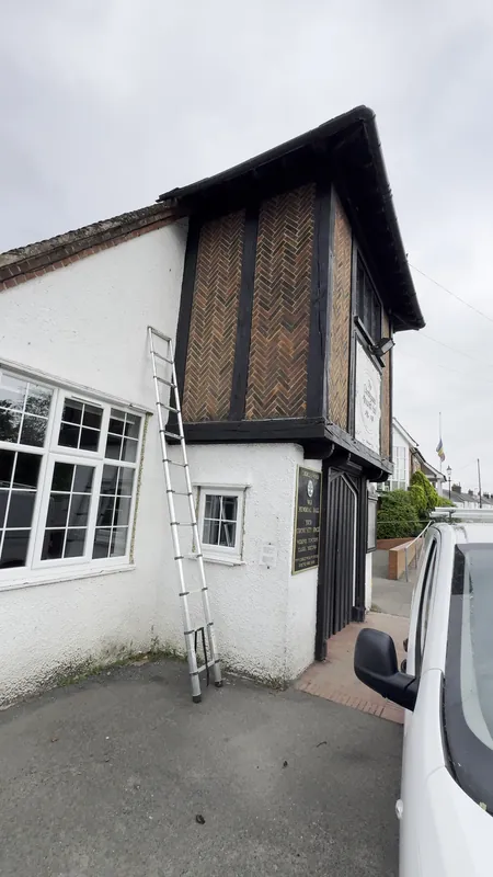 The tower and side wing: woodwork and pebble dash painted — before