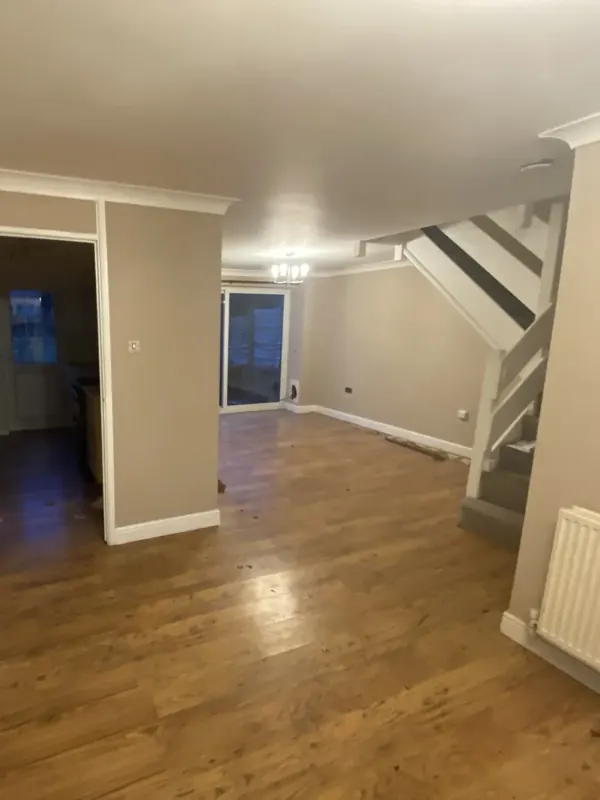Living room: new oak flooring, staircase, lighting and media wall — before