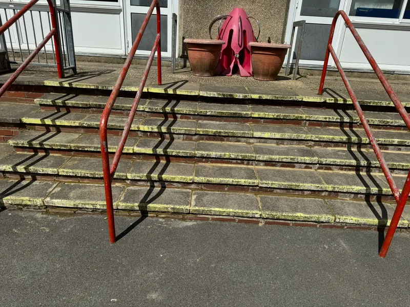 The steps up to the classroom doors, repaired and repointed — after