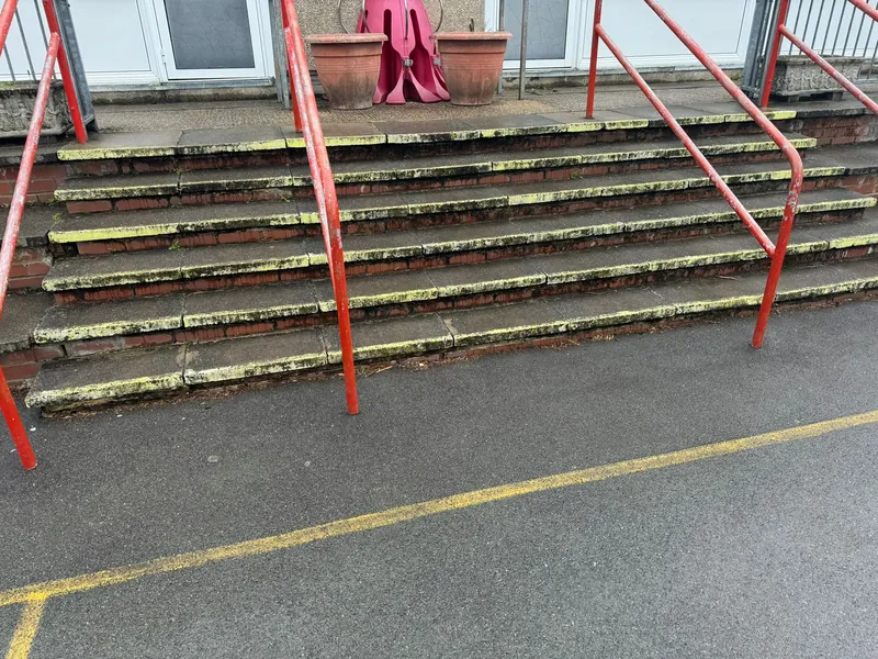 The steps up to the classroom doors, repaired and repointed — before