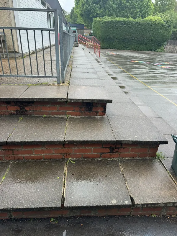 The long playground steps: cracked joints raked out and repointed — before