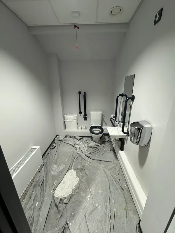 Toilets sheeted up before painting