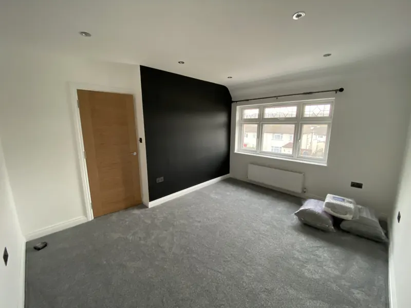 Bedroom with a dark feature wall