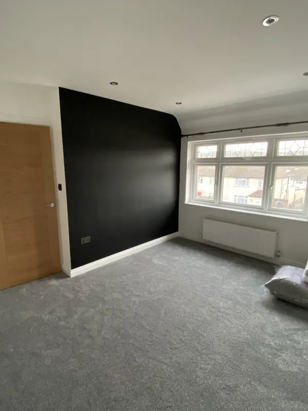 Bedroom with a dark feature wall in Edgware