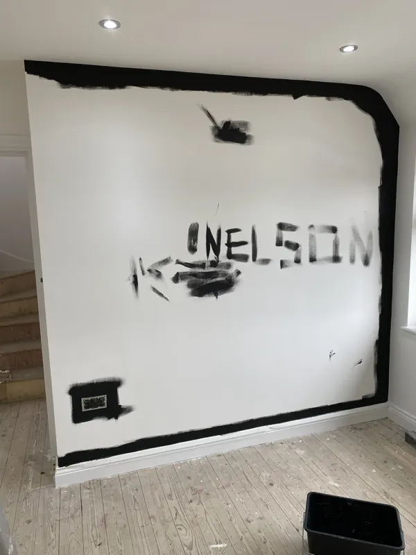 Feature wall marked out, then finished in black — during
