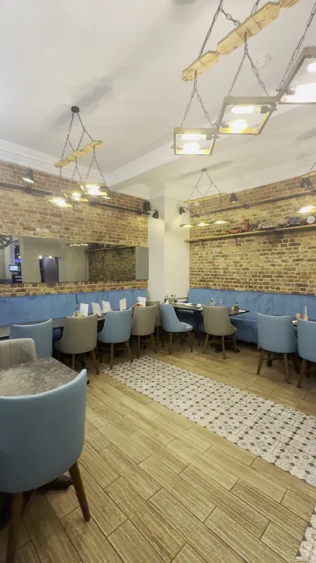 Brick feature wall and banquette seating area — after