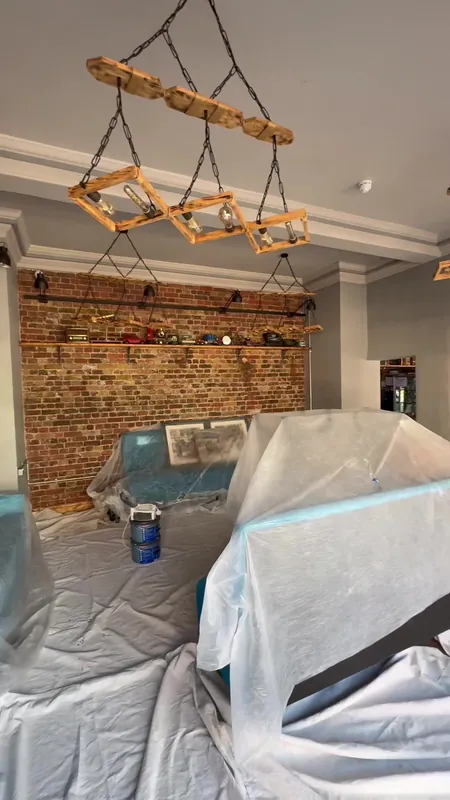 Brick feature wall and banquette seating area — during