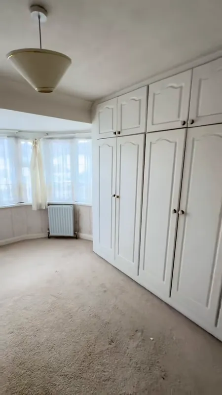 The bay-window bedroom, wardrobes refreshed — before