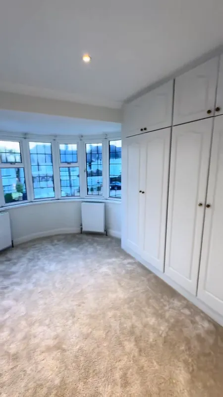 The bay-window bedroom, wardrobes refreshed — after