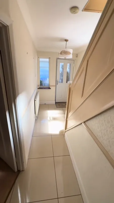 The hallway, looking to the front door — before