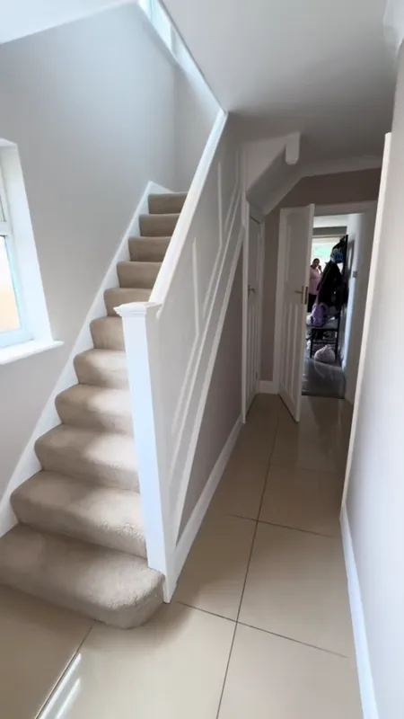 The staircase, with the panelling painted white — after