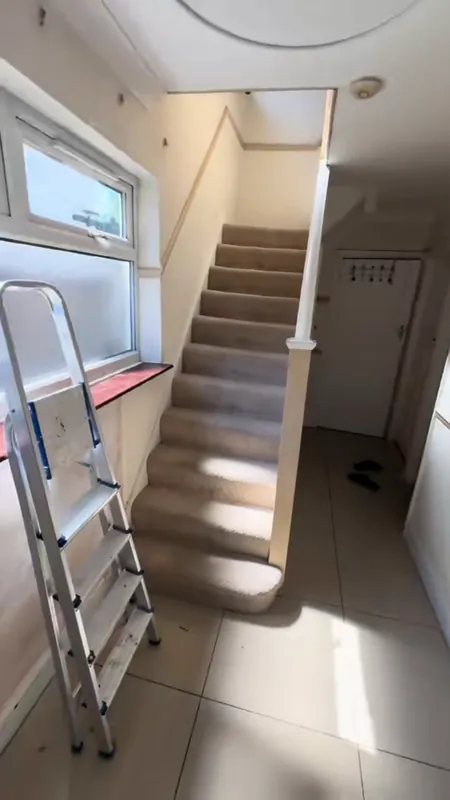 The staircase, with the panelling painted white — before