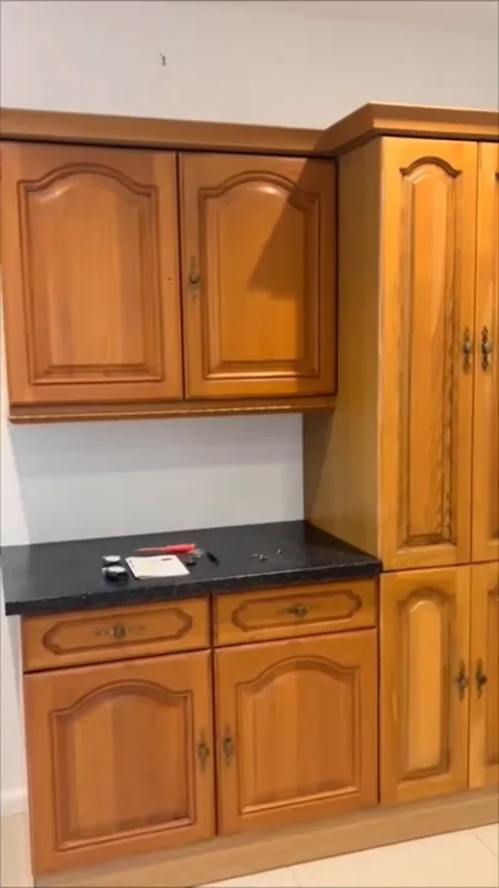 The tall larder unit and the wall units beside it — before