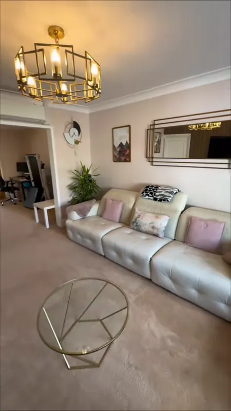 The living room: old wallpaper gone, walls a warm peach — after