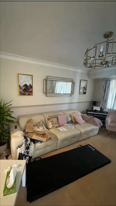 The living room: old wallpaper gone, walls a warm peach — before