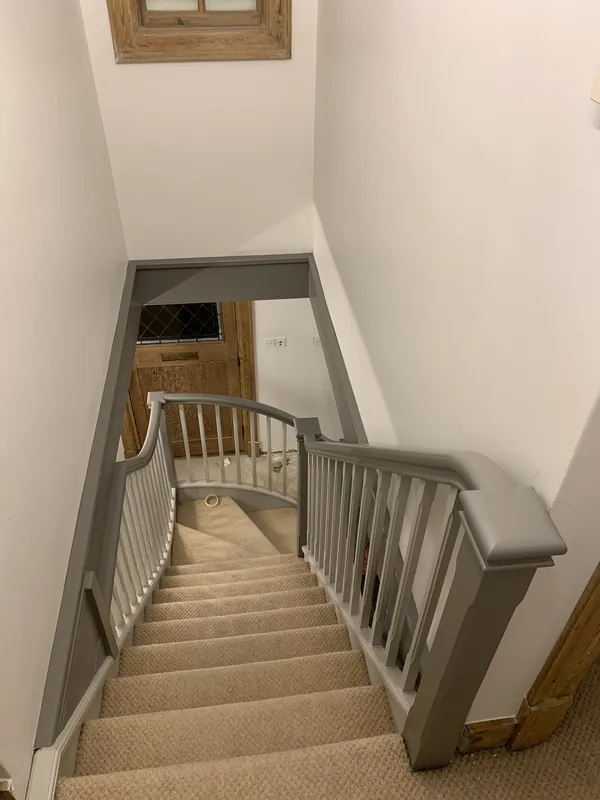 The landing balustrade, looking down the stairs — after