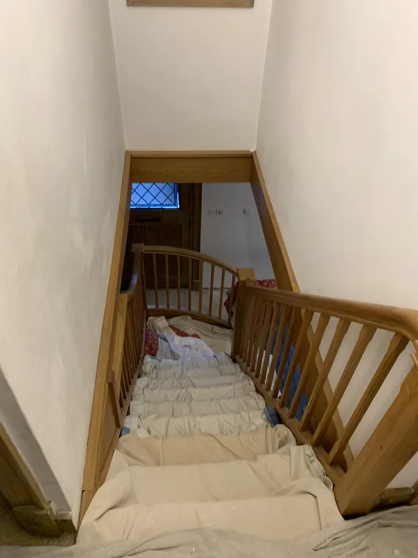 The landing balustrade, looking down the stairs — before