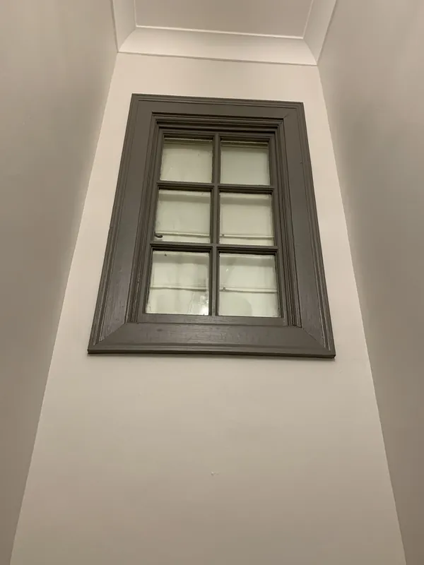 The stairwell window, painted grey