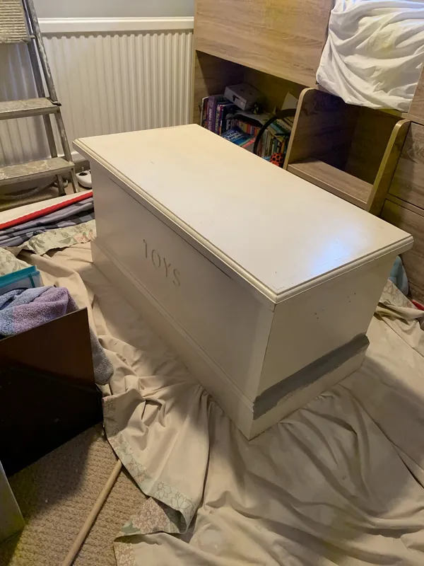 The toy box, painted to match — before