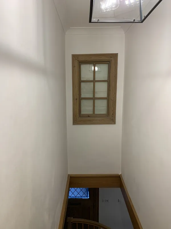 The stairwell window frame — before