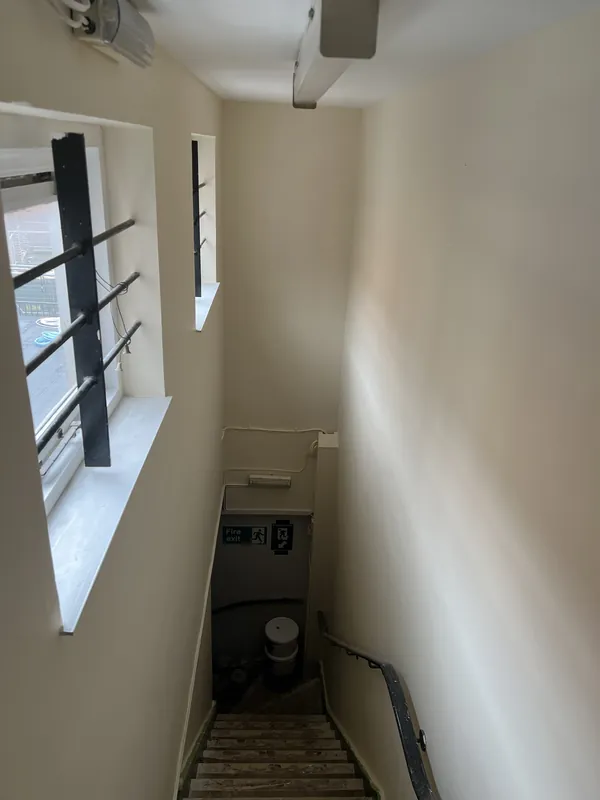 Stairwell window wall: filled, sanded and painted — after