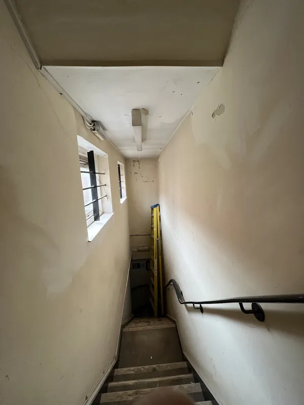 Stairwell window wall: filled, sanded and painted — before