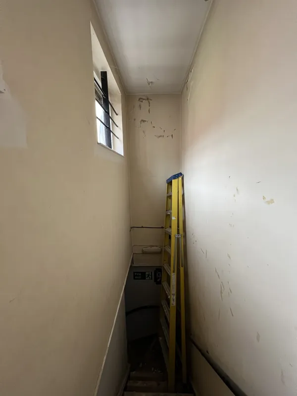 Stairwell before: cracks and flaking paint