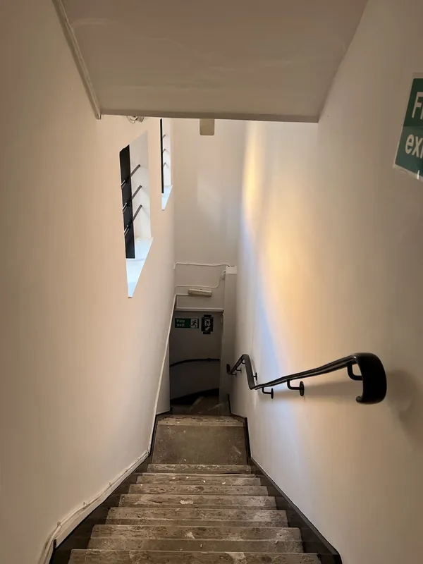 Stairwell from the top: cracks and flaking paint made good, then painted — after