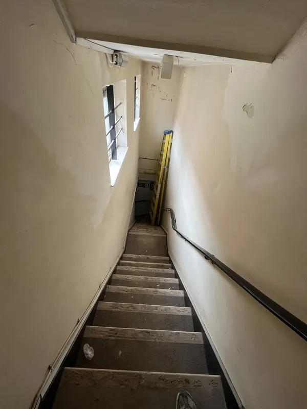Stairwell from the top: cracks and flaking paint made good, then painted — before