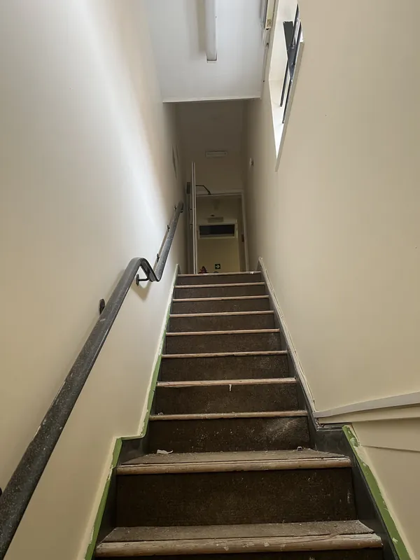 Stairwell freshly painted, edges still taped