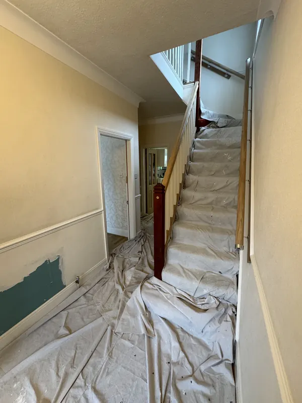 Hallway and staircase from the same spot, before and after — before