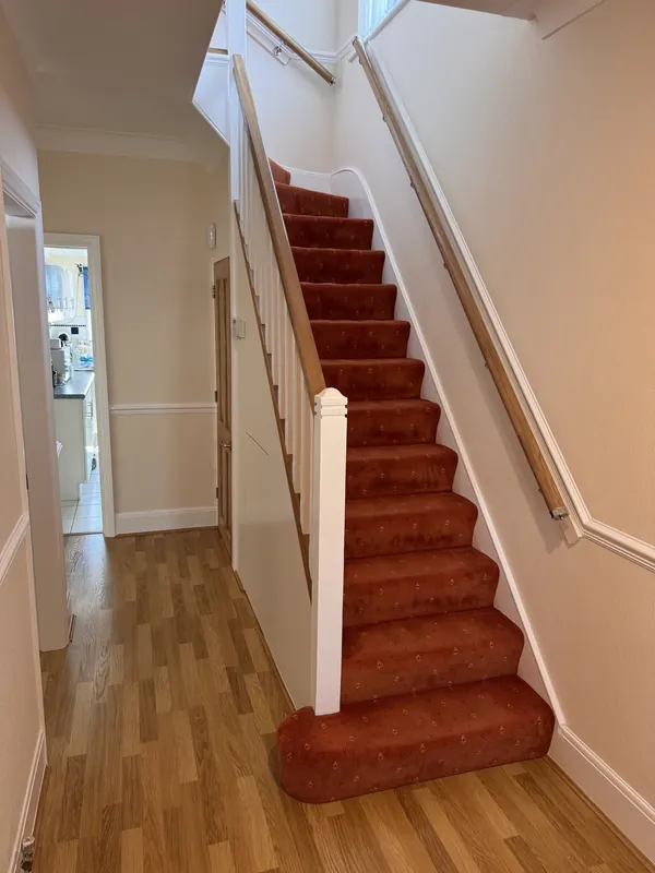 Staircase with white spindles and newel post