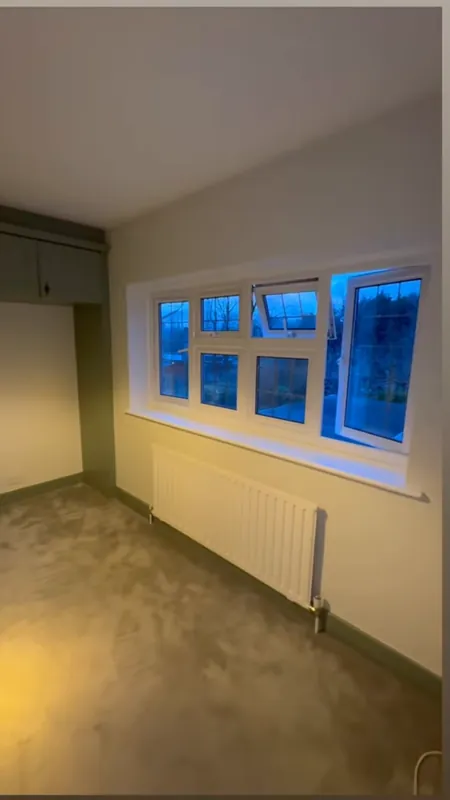 The window wall, with the old shelves and desk gone — after