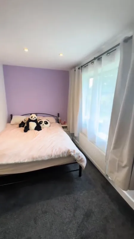 The corner by the window: the green being painted over, then the finished sugared lilac accent wall — after