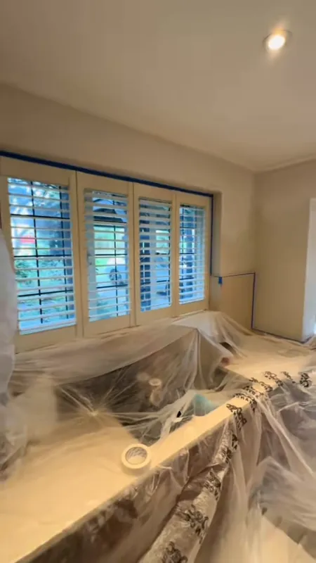 Sheeted and protected, then finished: the window wall — during